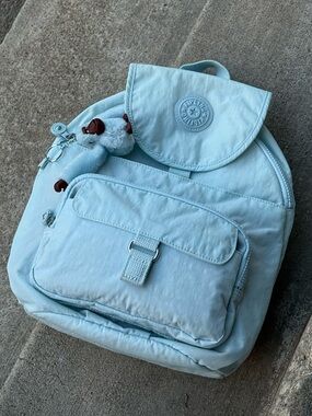 KIPLING “QUEENIE” PALE BLUE MINI BACKPACK WITH COREY GORILLA KEYCHAIN